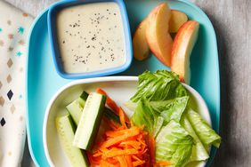 a photo of Kid-Friendly Salad with the vegetables, fruit, and dipping sauce portioned out