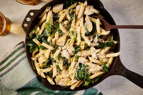 Overhead view of a cast iron skillet of Chicken & Spinach Skillet Pasta with Lemon & Parmesan recipe