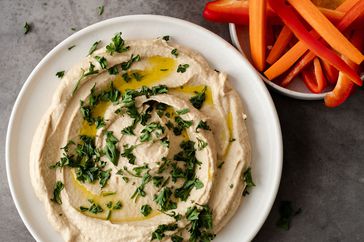 hummus in bowl with herbs