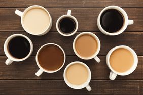 a photo of coffee mugs with different amounts of milk in them