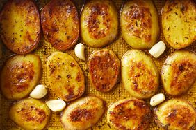 Overhead view of cooked potato slices on a baking sheet from Melting Potatoes recipe