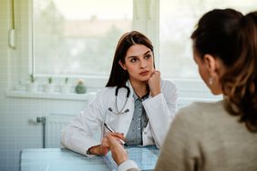 a photo of a doctor speaking to their patient 