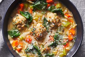Bowl of Easy Italian Wedding Soup on a gray cloth background
