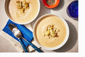 two bowls of roasted cauliflower curry soup