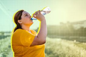 a photo of a woman drinking a bottle of water outside