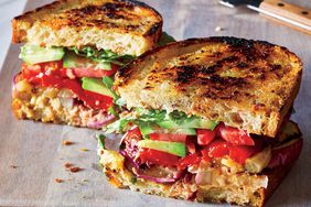 The Ultimate Vegetarian Club Sandwich recipe sliced on a cutting board
