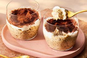 side shot of two glass jars filled with creamy oats and topped with cocoa powder