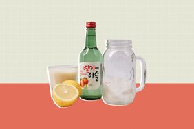 A bottle and glass of Soju with a sliced lemon